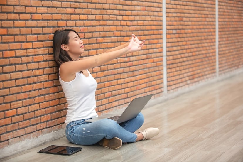 Sit against a wall and press your wrists back for a stretch.