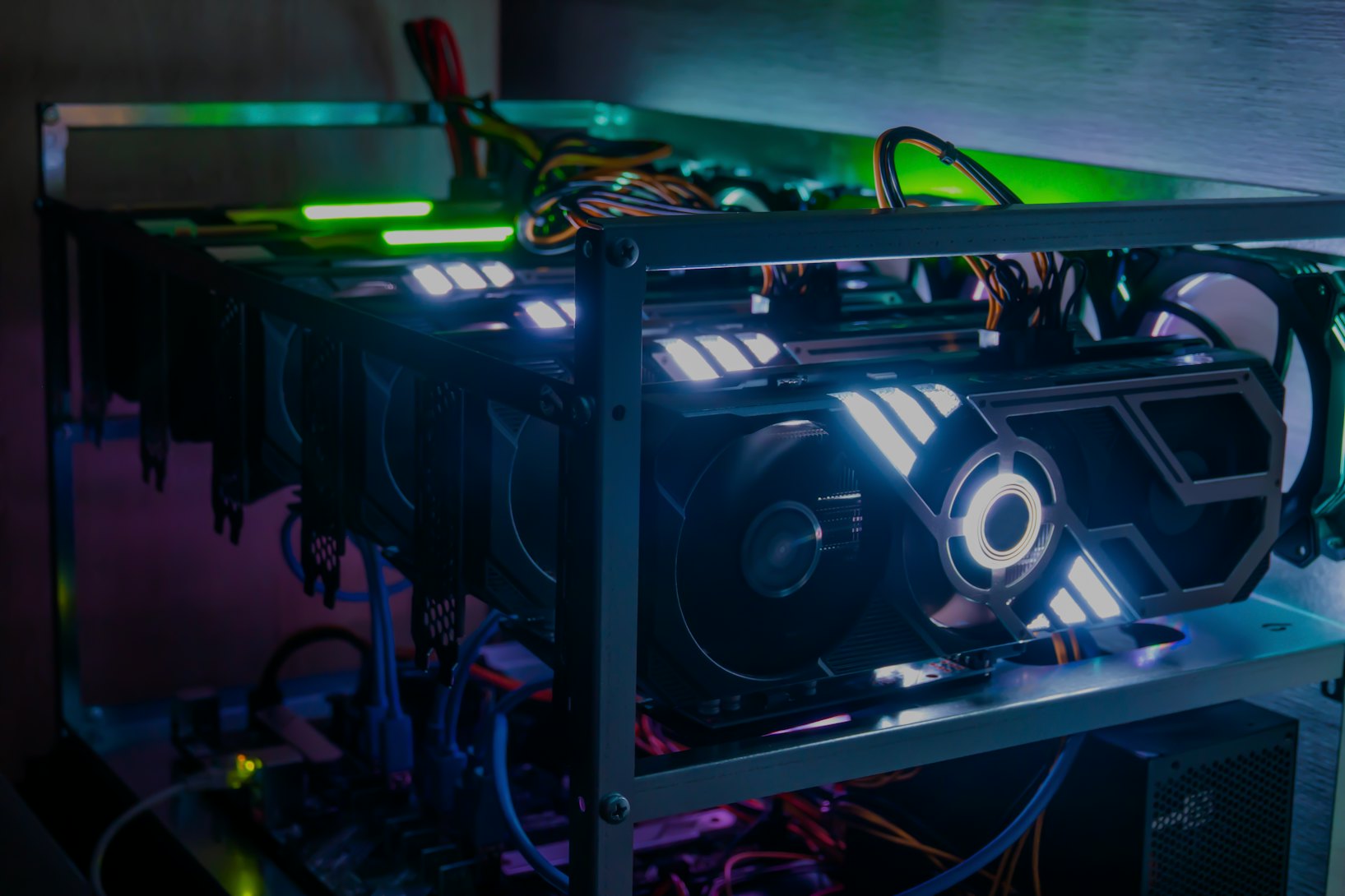 Rig of six video cards. Cryptocurrency concept. gpu render farm. Mining background. Neon LED backlig...