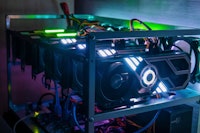 Rig of six video cards. Cryptocurrency concept. gpu render farm. Mining background. Neon LED backlig...