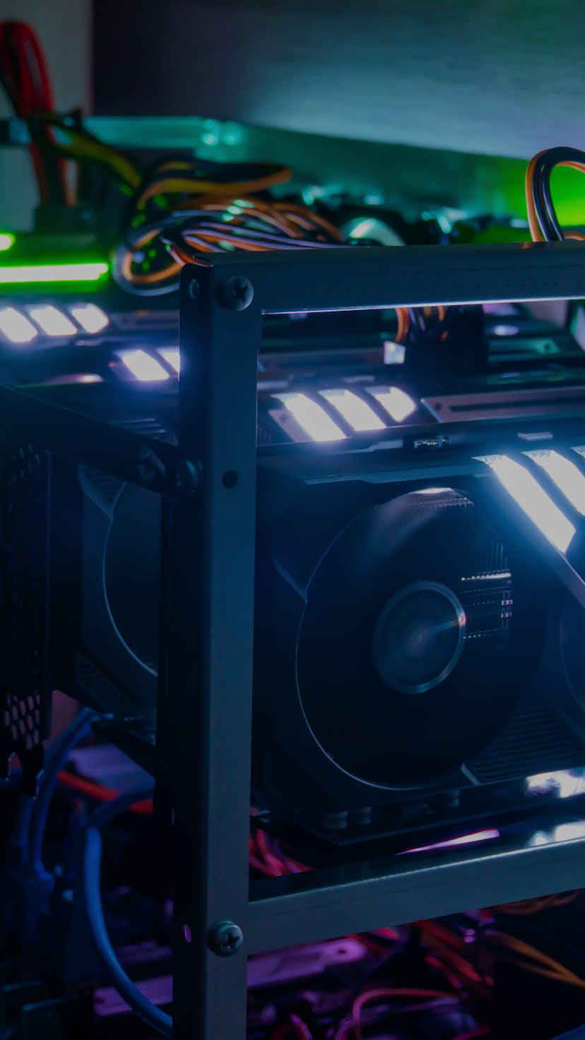 Rig of six video cards. Cryptocurrency concept. gpu render farm. Mining background. Neon LED backlig...