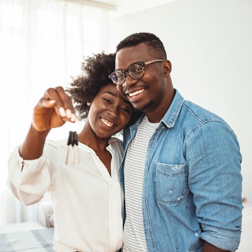 couple holding a key after moving in together