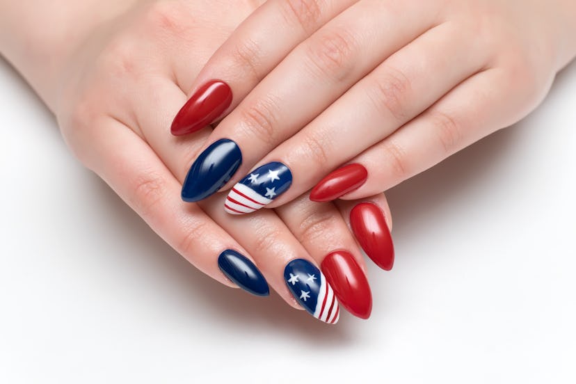 Red and blue nails with an American flag design for Fourth of July on long sharp nails.