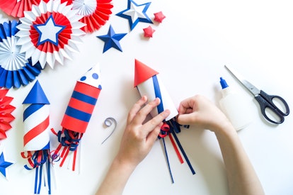 Diy 4th of July decor color American flag. Patriotic holiday. Process kid children craft. Rocket wit...