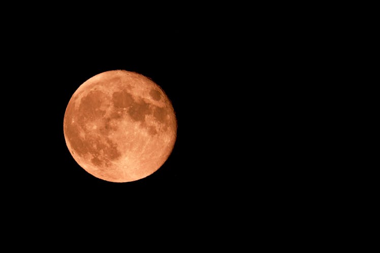 Red strawberry moon and black sky