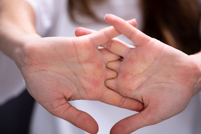 Close-up Of Woman Cracking Their Knuckles At Home