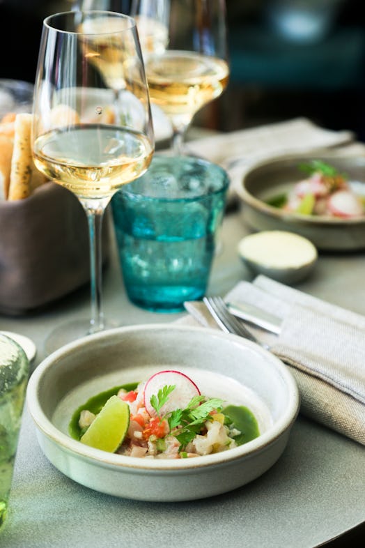 Fish ceviche served with green sauce and lime