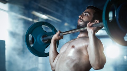 Close-up of a Muscular Shirtless Man Lifting Heavy Barbell and Doing Military Press Bodybuilding Exe...