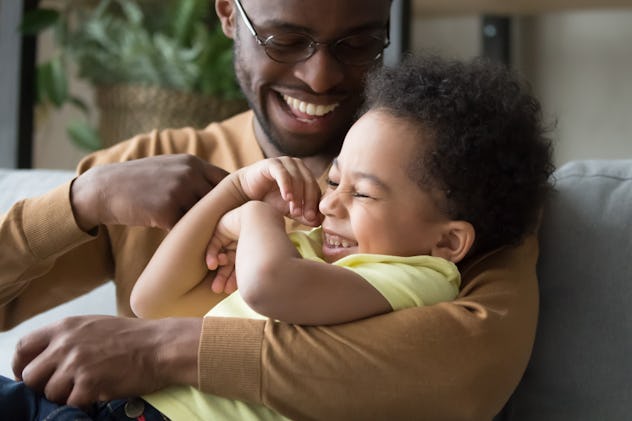 Father and son wearing yellow and laughing together at father's day riddles