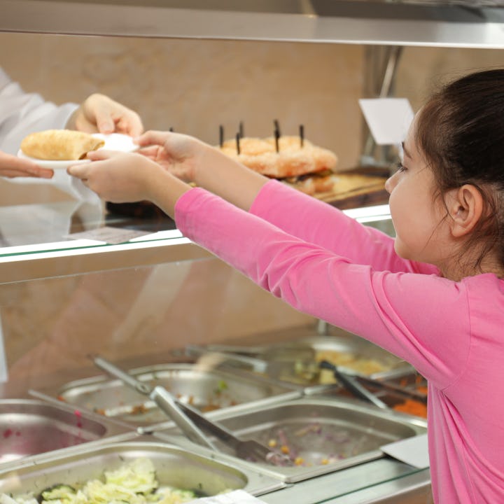 A girl getting school lunch. The waivers that have allowed public schools to provide free meals to s...