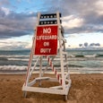 Lifeguard stand with no lifeguard on duty as the sun sets on lake Michigan.  Lighthouse beach, Evans...