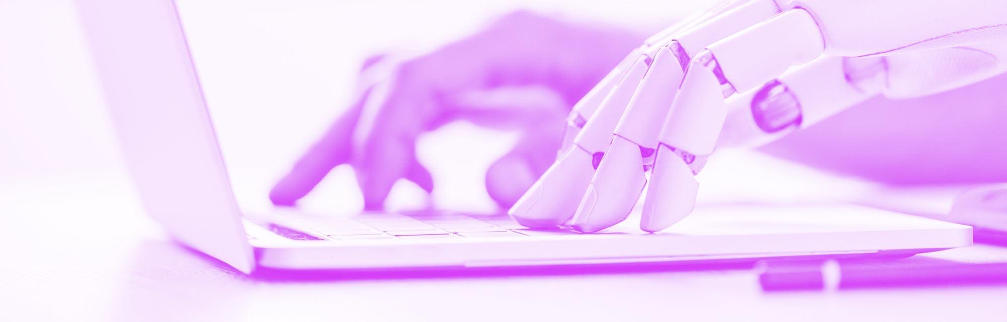 selective focus of human and robot hands typing on laptop at workplace