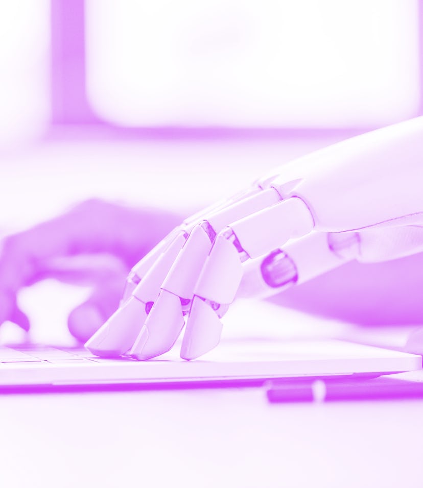 selective focus of human and robot hands typing on laptop at workplace