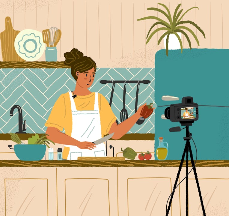 Food video blogger cooking and live streaming online. Woman chef showing recipe on camera in vlog. C...