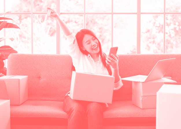 Happy young Asian woman entrepreneur, Smile for sales success after checking order from online shopp...