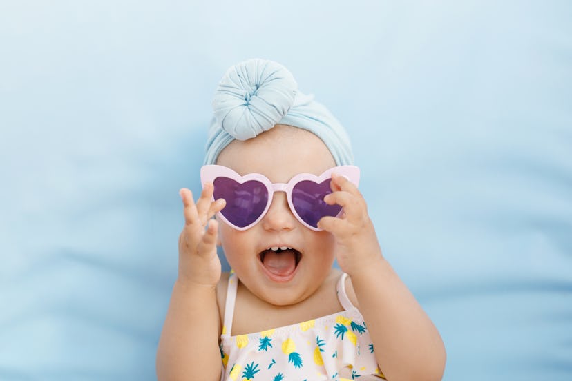 Funny cute baby girl on summer vacation in an article about baby girl names that start with P