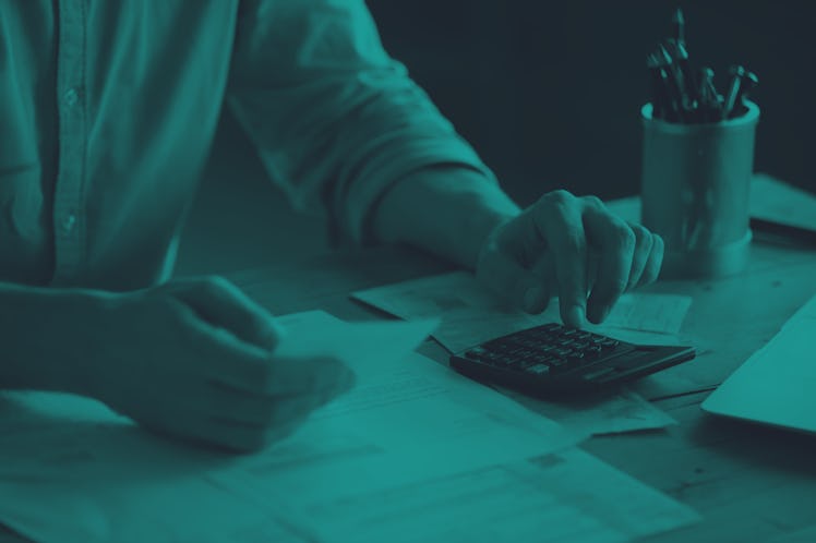 Personal finance management, accounting concept. Close up view man sitting at table using calculator...