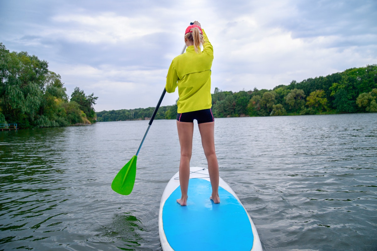 The twisting motion of paddling engages the core muscles.