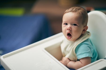 a baby coughs in his high car