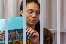 Star and two-time Olympic gold medalist Brittney Griner holds up a photo of players from the recent ...