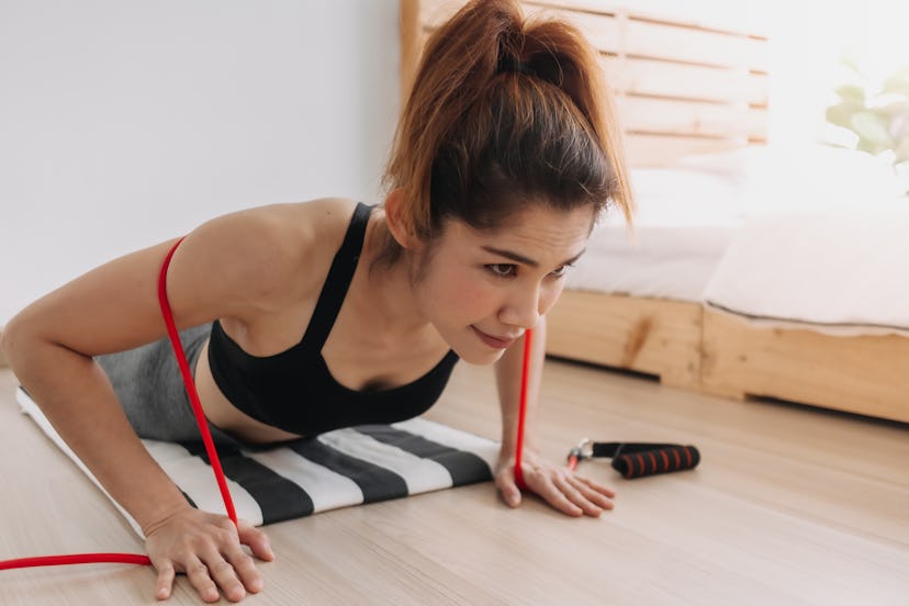 Place a resistance band over your back as you do push-ups.