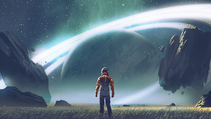 Sci-fi scene showing futuristic man standing in a field looking at the planet with giant rings, digi...