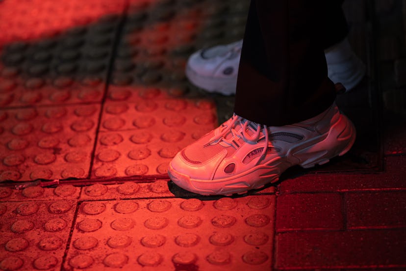 A red light is projected onto the pavement as a novel safety warning in Hong Kong, China, 07 July 20...
