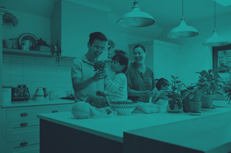 Asian Family Unpacking Local Food In Zero Waste Packaging From Bag In Kitchen At Home