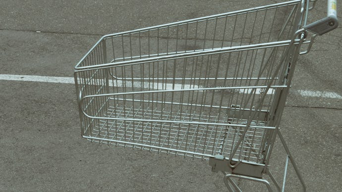 close up of empty shopping cart at parking near grocery store. crisis customers can't afford buying ...