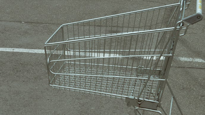 close up of empty shopping cart at parking near grocery store. crisis customers can't afford buying ...