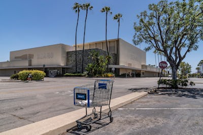 This, photo shows an empty shopping cart in an empty parking lot at the closed Sears in Buena Park M...