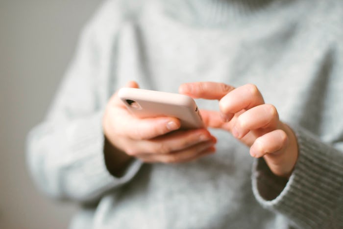Woman using a mobile phone on white background