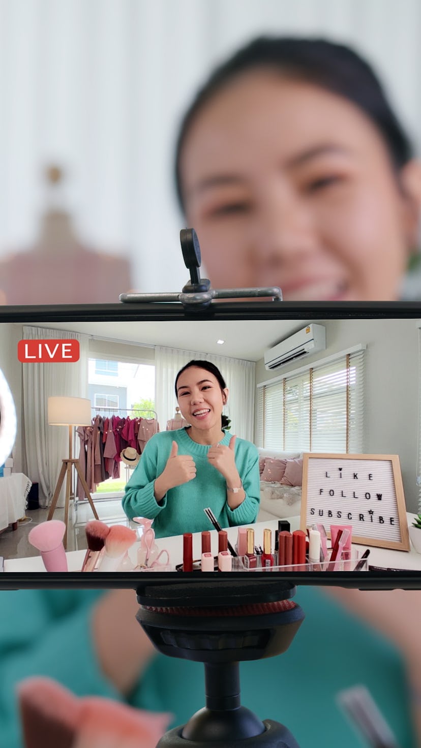 A woman films a vlog. YouTube shorts vs. TikTok.