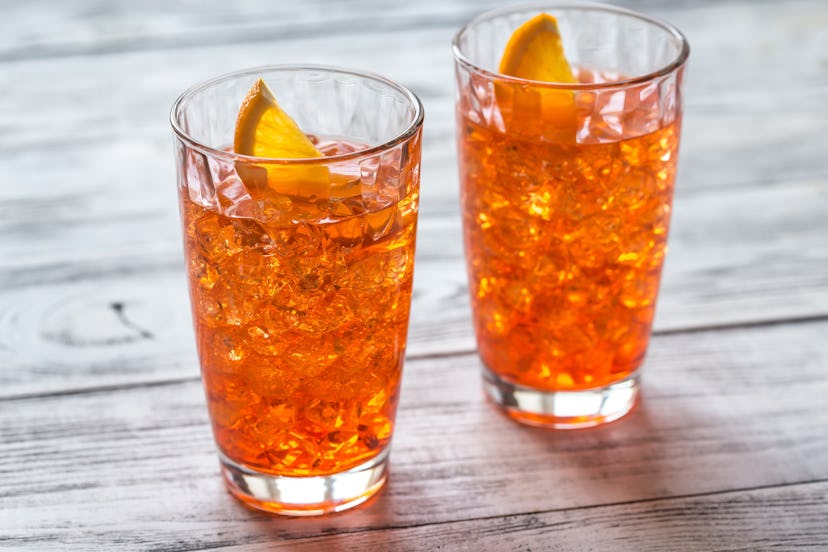 Glass of Aperol Spritz cocktail on the white wooden background