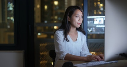 Woman work on computer at night