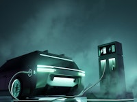 Futuristic looking electric car and charging station. e-car and substainable green energy and transp...