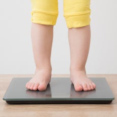 A child stands on a scale. A new study has found rising rates of childhood obesity.