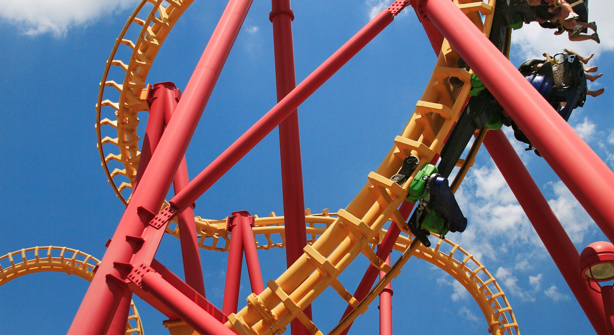 Scary Upside Down Fun With A Colorful Looping Roller Coaster On A Beautiful Sunny Day At The Amuseme...