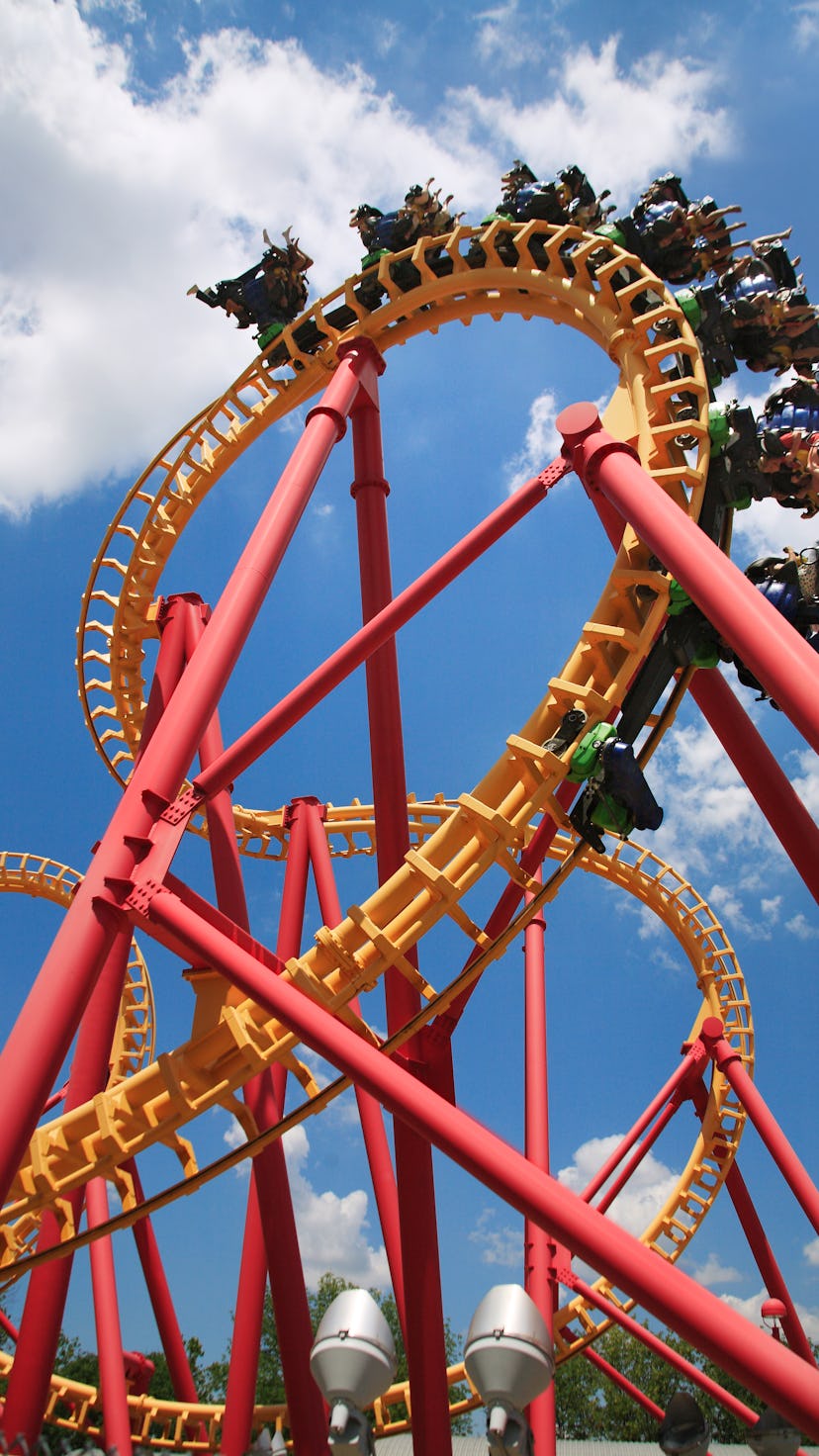 Scary Upside Down Fun With A Colorful Looping Roller Coaster On A Beautiful Sunny Day At The Amuseme...