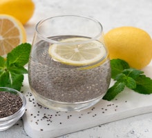 
A glass of water with chia seeds and lemon on a white background.
Slimming drink.