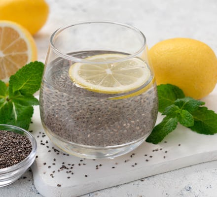 
A glass of water with chia seeds and lemon on a white background.
Slimming drink.