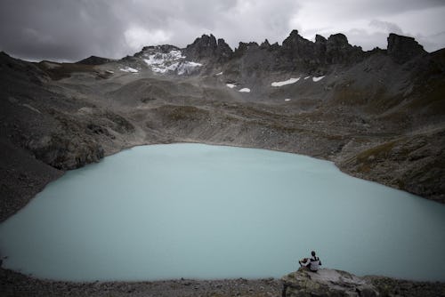 A hiker plays his accordeon with view of Wildsee and the Pizol glacier, on the sideline of a commemo...