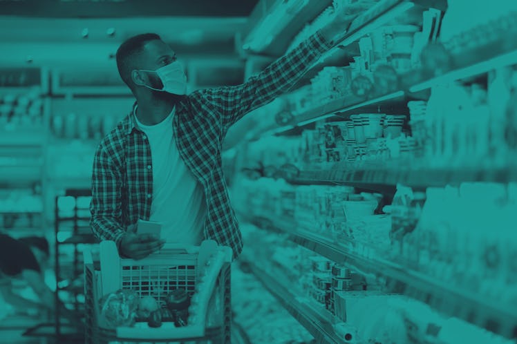 African American Man Doing Grocery Shopping In Supermarket, Wearing Protective Face Mask, Buying Foo...