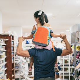 Father and daughter buying school supplies preparing to go back to school, preparing for september, ...