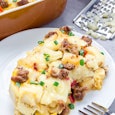 Egg casserole with potatoes, sausage and pepper, on white plate, vertical