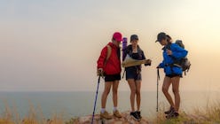 Group asia friends traveler with backpack adventure holding map to find directions and walking relax...