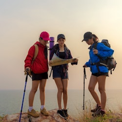 Group asia friends traveler with backpack adventure holding map to find directions and walking relax...