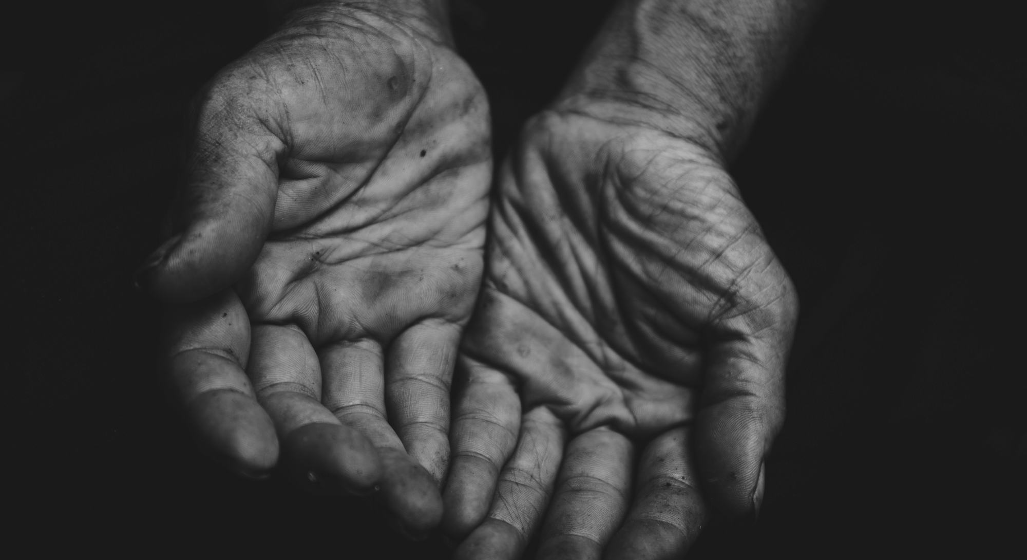 close up hands poor old man or beggar begging you for help sitting at dirty slum. concept for povert...