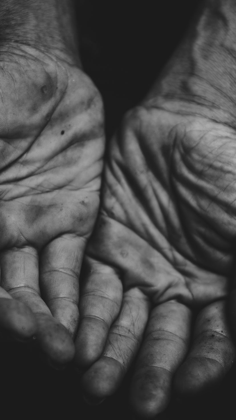 close up hands poor old man or beggar begging you for help sitting at dirty slum. concept for povert...