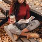 A woman reading a book surrounded by fallen leaves. Keep an eye out for these highly anticipated rel...