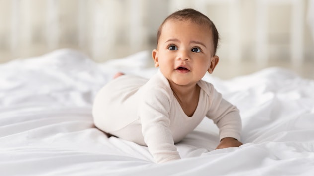 cute baby in a bed in a round up of baby girl names that start with L